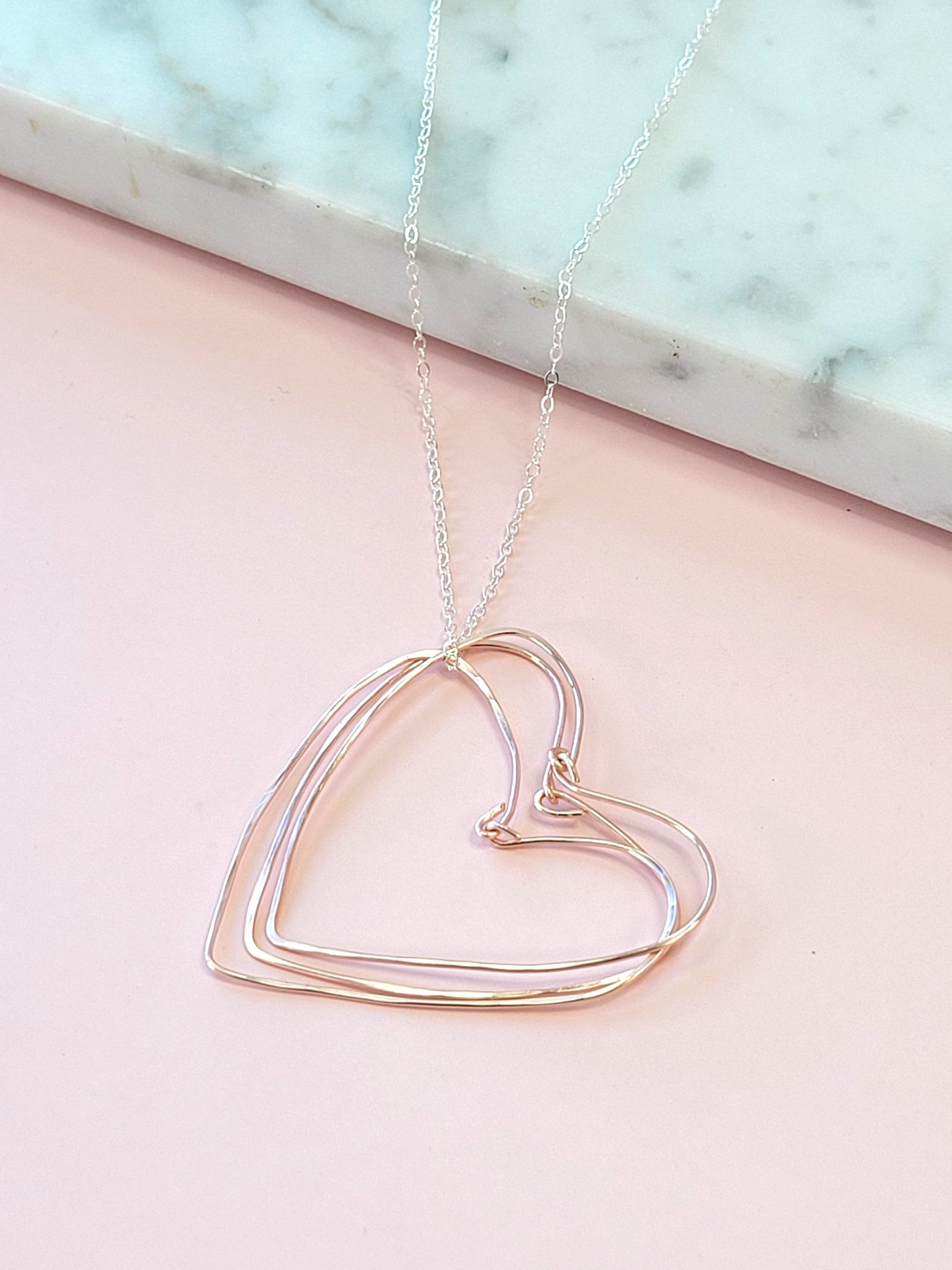 Rose Gold Hearts Necklace on a Silver Chain